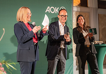 Die Vorstände der AOK Bayern halten eine Rede Die Vorstände der AOK Bayern halten eine Rede
