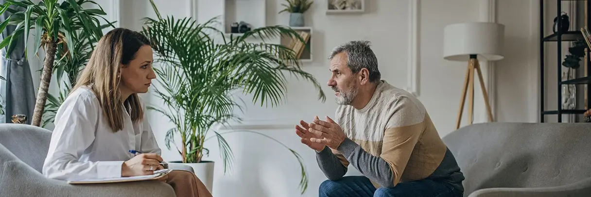 Symbolbild für Psychotherapie: Eine Therapeutin im Gespräch mit einem Klienten