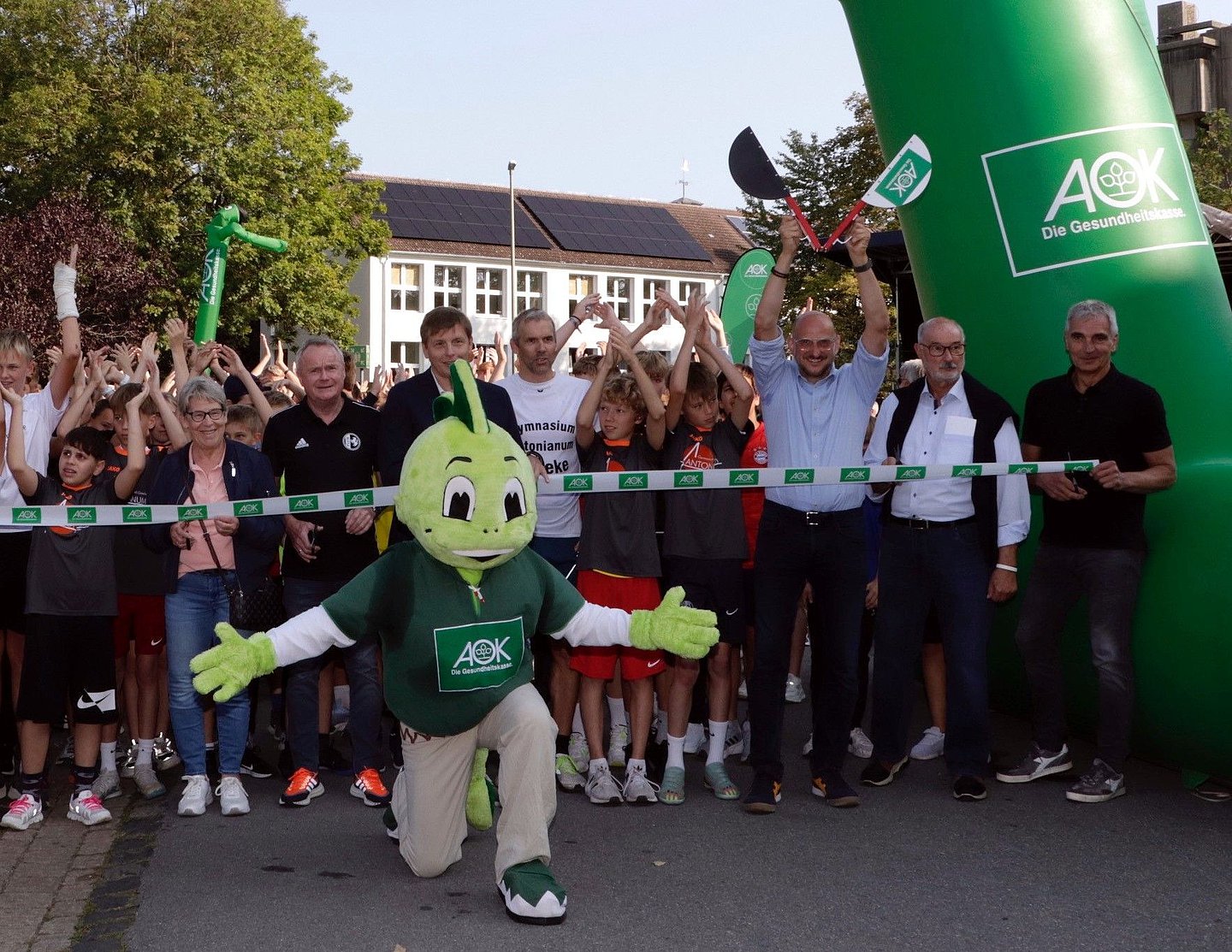 Das Foto zeigt AOK-Marketingleiter Dirk Pisula, wie er das Startsignal für den Auftakt zum landesweiten Laufabzeichen-Wettbewerb in Geseke gibt.